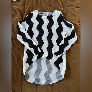 Black and white striped sweater, shorter in front/longer in back.